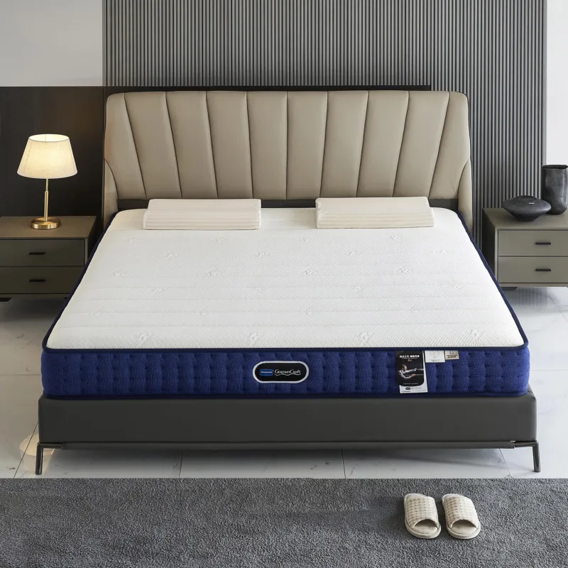 White and navy blue mattress with quilted top and textured sides, shown with pillows